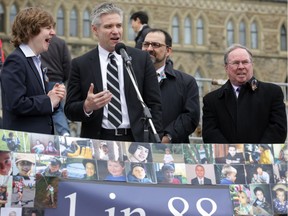 Jaden Lake, 17, who has autism, yawns as his father, Edmonton MP Mike Lake  addresses  the first World Autism Awareness Day crowd on Parliament Hill in Ottawa on March 27, 2014.