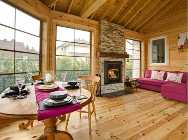 Rustic pine and a wood-burning fireplace add to the charm of the Sumners’ three-season room.