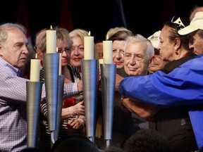 Holocaust survivors gather to light a candle during National Holocaust Remembrance Day ceremonies at the Canadian War Museum.