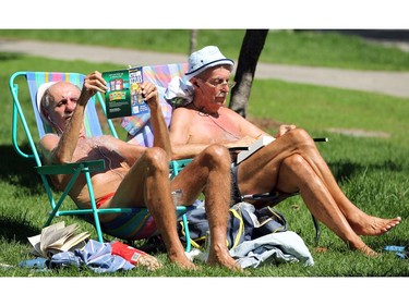 With the sun shining and temperatures above 25 degrees, Gary Routliffe (left) and Ken Lane broke out the bathing suits and beach chairs smack downtown Tuesday, at Minto Park off Elgin Street.