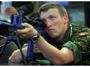 Participants in last year's CANSEC event, which featured everything from tanks and guns to simulators for jet pilots, lined up to give a sniper simulator a whirl.