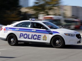 OTTAWA, ON: OCTOBER 2, 2013 - Lights and siren on, an Ottawa police cruiser vehicle races to a call in Ottawa on Wednesday, October 2, 2013.. (photo by Mike Carroccetto / Ottawa Citizen)���(for WEB / CITY story by ??) NEG# 114648