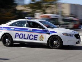 OTTAWA, ON: OCTOBER 2, 2013 - Lights and siren on, an Ottawa police cruiser vehicle races to a call in Ottawa on Wednesday, October 2, 2013.. (photo by Mike Carroccetto / Ottawa Citizen)���(for WEB / CITY story by ??) NEG# 114648