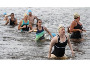 Kelly-Anne Gibson (#318), exits the water as she participates in the Super Sprint Triathlon, during the National Capital Triathlon and  Duathlon,  at Mooney's Bay in 2013.