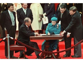 The Queen signs Canada's constitutional proclamation in Ottawa on April 17, 1982, in the presence of then-prime minister Pierre Trudeau.
