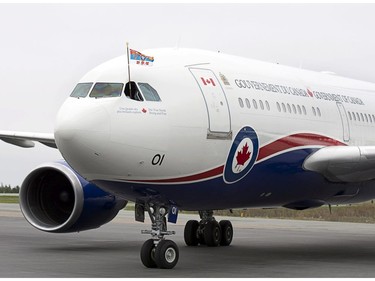 A pilot flies The Prince of Wales' Canadian standard from the cockpit as Prince Charles and his wife Camilla arrive at the airport in Halifax as they start a four-day tour of three provinces on Sunday, May 18, 2014. This is Charles' 17th visit to Canada and the couple's third Canadian tour since 2009.