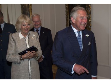 Prince Charles laughs after being sworn in as a member of the Privy Council as his wife Camilla and Governor General David Johnston look on in Halifax on Sunday, May 18, 2014. The Royal couple begin a four-day tour of Canada.
