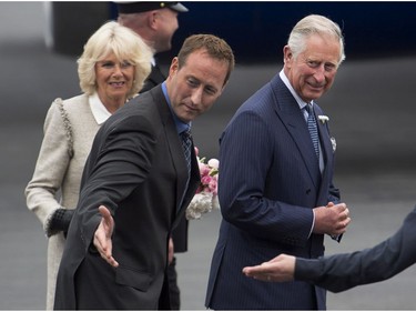 Prince Charles and his wife Camilla are directed to their car by Justice Minister Peter MacKay as they arrive at the airport in Halifax as they start a four-day tour of three provinces on Sunday, May 18, 2014. This is Charles' 17th visit to Canada and the couple's third Canadian tour since 2009.