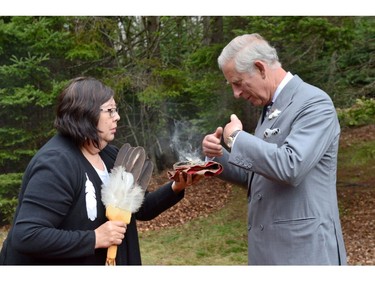 ePrince Charles takes part in a smudging ceremony with Chief Matilda Ramjattan in Bonshaw Provincial Park, P.E.I. on Tuesday, May 20, 2014.