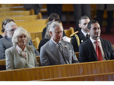 Prince Charles, centre, his wife Camilla and P.E.I Premier Robert Ghiz listen to a musical presentation by a combined choir from local churches on Tuesday, May 20, 2014 in Cornwall, P.E.I. The Royal couple are on a four-day tour of Canada.