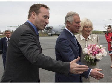 Prince Charles, centre, and his wife Camilla, right, are greeted by Justice Miniter Peter MacKay as they arrive Sunday, May 18, 2014 in Halifax. The Royal couple begin a four-day tour of Canada.