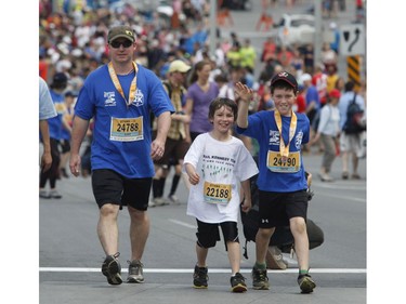 Runners participate in the 2k run during the Ottawa Race Weekend on Saturday May 24, 2014.