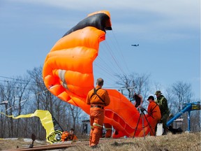 SAR Techs grapple with an unruly parachute.