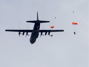 Search and rescue technicians (SAR techs) parachute from a CC-130H Hercules aircraft during Tigerex 2014 at Mont Cascades Ski Resort in Cantley, Que. on Tuesday, May 6, 2014.