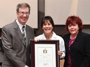 Shelby Hayter receives her Mayor’s City Builder Award, flanked by Mayor Jim Watson and Coun. Jan Harder.
