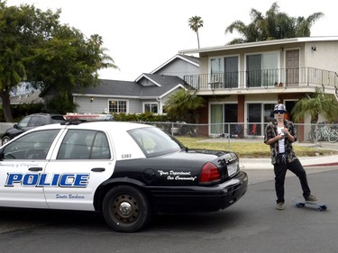 A young man views one of the nine crime scenes where a man went on a killing rampage at the University of California at Santa Barbara college town of Isla Vista, California, USA, 24 May 2014. The suspect killed six people and wounded seven as he drove through the college town shooting as well as running over victims in his car before he died either in the shoot-out with police or from a self-inflicted wound.