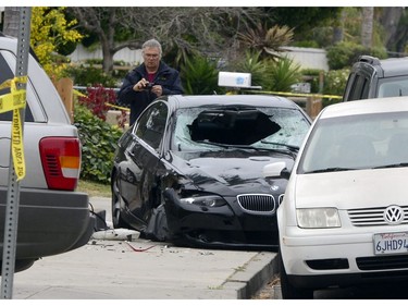 A policeman photographs the car of the shooting suspect who went on a killing rampage at the University of California at Santa Barbara college town of Isla Vista, California, USA, 24 May 2014. The suspect killed six people and wounded seven as he drove through the college town shooting as well as running over victims in his BMW car before he died either from the shoot-out with police or from a self-inflicted wound.