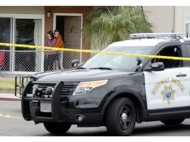 Two women view one of the nine crime scenes where a man went on a killing rampage at the University of California at Santa Barbara college town of Isla Vista, California, USA, 24 May 2014.  The suspect killed six people and wounded seven as he drove through the college town shooting as well as running over victims in his car before he died either in the shoot-out with police or from a self-inflicted wound.