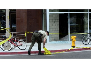 A policeman inspects one of the crime scenes where a man went on a killing rampage at the University of California at Santa Barbara college town of Isla Vista, California, USA, 24 May 2014. The suspect killed six people and wounded seven as he drove through the college town shooting as well as running over victims in his car before he died either in the shoot-out with police or from a self-inflicted wound.