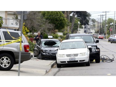 A policeman inspects the car of the shooting suspect who went on a killing rampage at the University of California at Santa Barbara college town of Isla Vista, California, USA, 24 May 2014. The suspect killed six people and wounded seven as he drove through the college town shooting as well as running over victims in his BMW car before he died either from the shoot-out with police or from a self-inflicted wound.