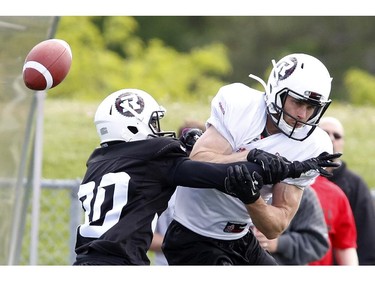 Simon Le Marquand (R) attempts a catch while Steven Adu blocks him at the CFL Ottawa Redblacks rookie camp at Keith Harris Stadium in Ottawa on Friday May 30, 2014.