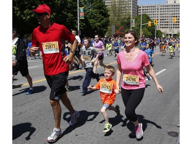 Soriya Thusky-Decontie, Yvan Roshkov and Lioudmila Roshkov participate in the 2k run during the Ottawa Race Weekend on Saturday May 24, 2014.