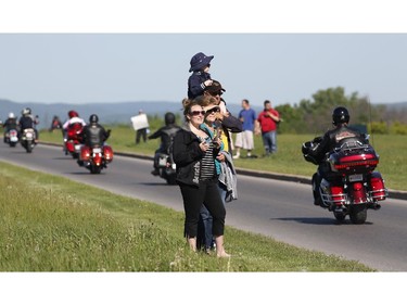 Spectators cheer on motorcyclists at the Ottawa TELUS Motorcycle Ride for Dad at the Canadian Aviation and Space Museum on Saturday May 31, 2014.
