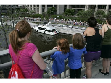 Spectators watch the 5k run during the Ottawa Race Weekend on Saturday May 24, 2014.