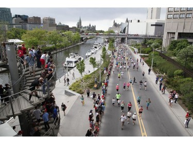 Spectators watch the 5k run during the Ottawa Race Weekend on Saturday May 24, 2014.