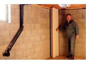 Steve Maxwell installs wall panels in a basement instead of stud frame walls.