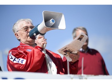 Supporter of the Greater Ottawa Truckers Association, Shirley Mosley  speaks to the crowd at the protest where147 Trucks and many supporters gathered at the Canadian Tire Centre parking lot to protest against the city on Saturday, May 10, 2014.