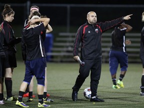 The Ottawa Fury FC women's coach Dom Oliveri talks to his players. The team is dominating the opposition this season.