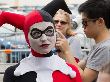 Thea Nikolic dressed as Harley Quinn, girlfriend of the Joker, poses for photos with fans as Ottawa Comiccon, which begins Friday at the EY Centre, held a press conference at Brother's Beer Bistro in the Byward Market. Photo taken on May 8, 2014.