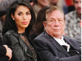 In this Dec. 19, 2010, file photo, Los Angeles Clippers owner Donald Sterling, right, and V. Stiviano, left, watch the Clippers play the Los Angeles Lakers during an NBA preseason basketball game in Los Angeles.