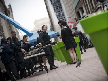 The Ottawa Police Service celebrate Police Week with "Community Day" to showcase various Ottawa Police sections such as Marine, Dive and Trails (MDT), District Traffic (motorcycle demonstration), Foot Patrol/Bicycle along Sparks Street Tuesday May 13, 2014. The Tactical Unit shows off some gear that they use to pedestrians walking by.