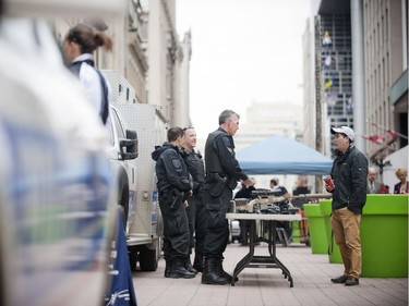 The Ottawa Police Service celebrate Police Week with "Community Day" to showcase various Ottawa Police sections such as Marine, Dive and Trails (MDT), District Traffic (motorcycle demonstration), Foot Patrol/Bicycle along Sparks Street Tuesday May 13, 2014. Mike Belanger of the Tactical Unit shows off some gear that is used to pedestrians walking by.