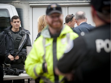 The Ottawa Police Service celebrate Police Week with "Community Day" to showcase various Ottawa Police sections such as Marine, Dive and Trails (MDT), District Traffic (motorcycle demonstration), Foot Patrol/Bicycle along Sparks Street Tuesday May 13, 2014. Jeremy House (left) of the Tactical Unit chats with pedestrians walking along Sparks Street Tuesday.