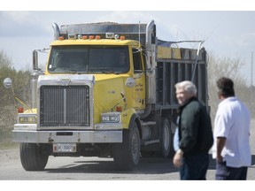 Trucks drive out of the Canadian Tire Centre parking lot where 147 Trucks and many supporters gathered to protest against the city on Saturday, May 10, 2014.