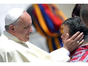 Pope Francis salutes a boy after his general audience at St Peter's Square on May 28 at the Vatican.