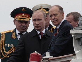 Russian President Vladimir Putin arrives on a boat after inspecting battleships during a navy parade marking the Victory Day in Sevastopol, Crimea, Friday, May 9, 2014.
