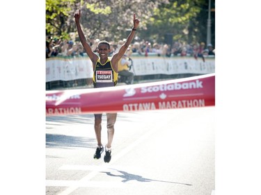 Yemane Tsegay crosses the finish line in first place for the marathon at Ottawa Race Weekend Sunday May 25, 2014.