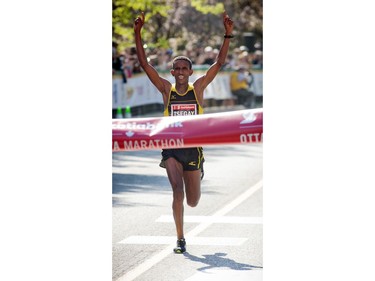 Yemane Tsegay crosses the finish line in first place for the marathon at Ottawa Race Weekend Sunday May 25, 2014.