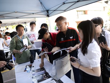 Visitors check out a luxury condo booth at the annual Community Welcome Fair for Immigrants and Newcomers, organized by the Ottawa Chinese Community Service Centre (OCCSC) on Sunday, June 1, 2014.