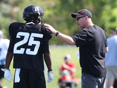 Head Coach ??? talks to Brandyn Thompson during ppening day of the Ottawa RedBlacks training camp, June 01, 2014.
