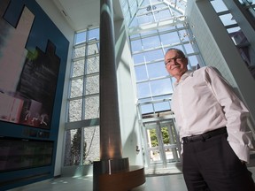 Robert Sirman, director and CEO for the Canada Council for the Arts, shows the art in the council's new public space at 150 Elgin St. The installation to the left is by  artist Rafael Lozano-Hemmer. Stare at the screen and your eyes begin to "smoke." (Photo by Wayne Cuddington/ Ottawa Citizen)