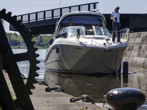 OTTAWA, ON: MAY 18, 2013 :  A boat makes its way through the Hog's Back locks on the Rideau Canal as the heritage waterway opens for the season. ( Chris Mikula / Ottawa Citizen) For CITY story Assignment # 113089