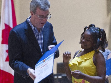 Shadia Bahati received her award from mayor Jim Watson, as the City of Ottawa honoured eleven young residents on Monday, June 9, 2014 for displaying good judgment at the 16th Annual 9-1-1 Children's Achievement Awards.