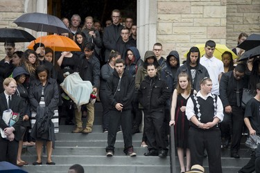 Mourners stand on the steps of St. Anthony's Church in Ottawa following his funeral on Friday, June 13, 2014. Volpi, a student at St. Patrick's High School was killed in a stabbing during his prom night in downtown Ottawa.