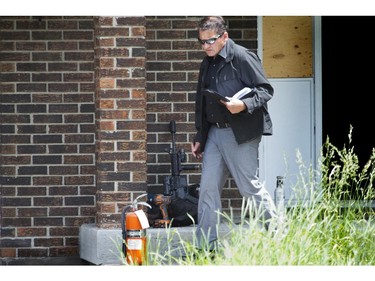 An investigator looks at the scene where two Ottawa police tactical officers and three paramedics have been injured in a joint-training exercise with the RCMP that was being conducted Wednesday morning on March Road in Kanata.