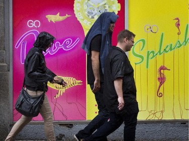 Pedestrians on Metcalfe between Wellington and Sparks streets on Tuesday, June 24, as warm wet weather with temperatures in the low 20's C with a chance of fog later in the evening.